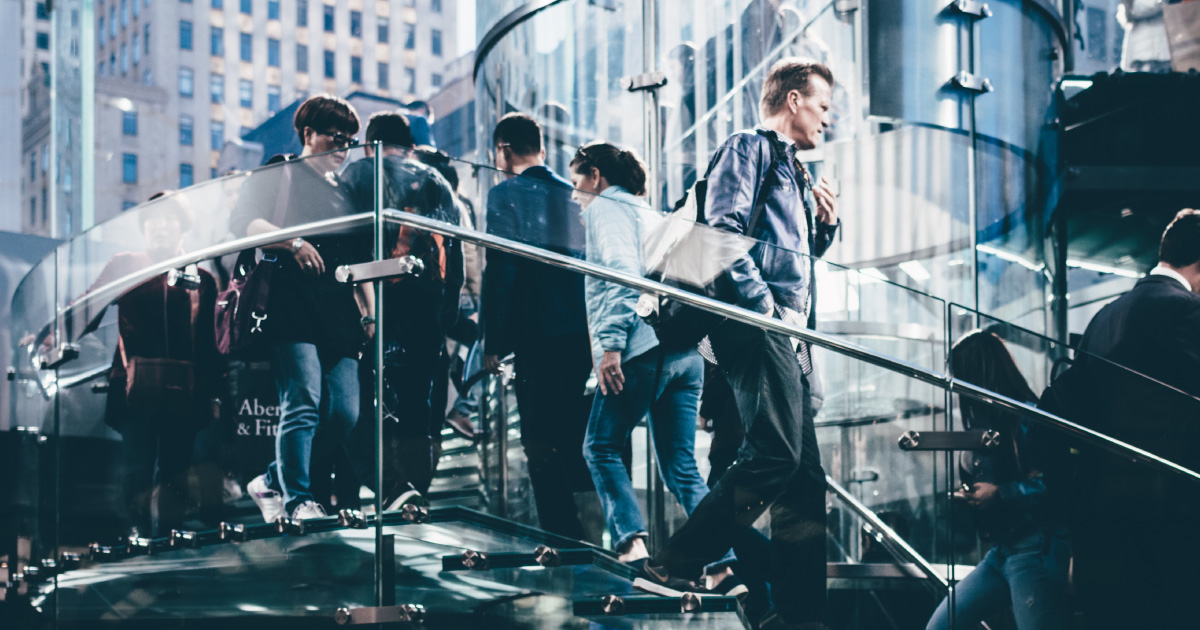 People walking on a glass staircase
