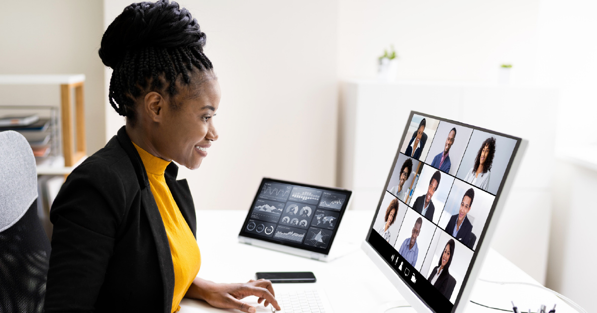 Three people smile during a video call for Highspot Spark 2020