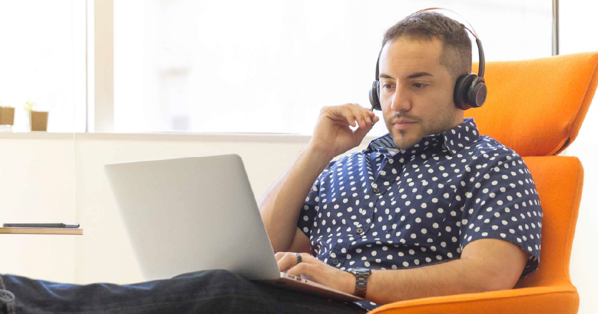 Person wearing headset looking at computer