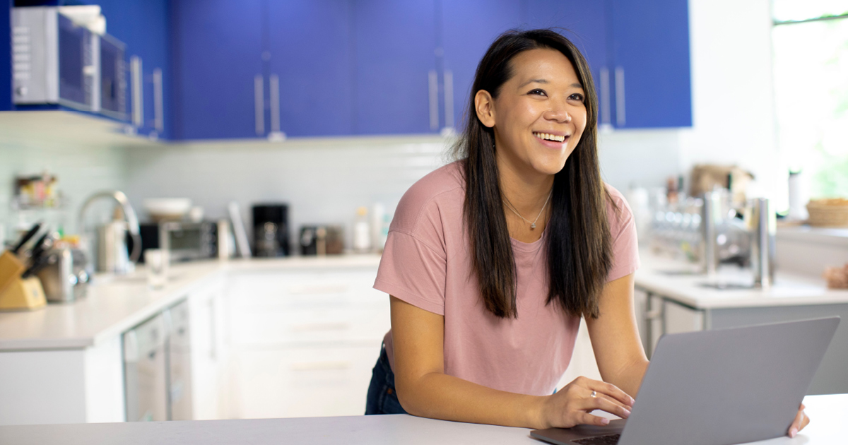 Person smiling in front of a computer