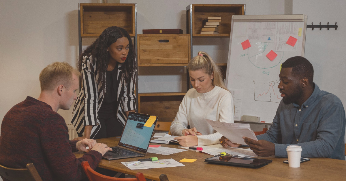 Four people in an enablement meeting