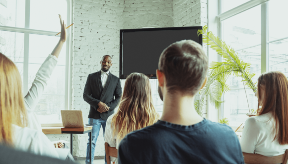 People conduct a meeting on essential revenue tech stack