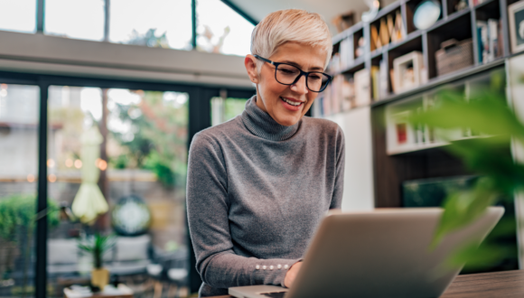 Person smiles at computer screen