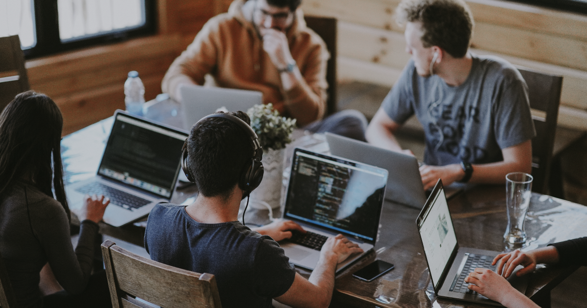 A team of people working on their individual laptops. Image from Highspot