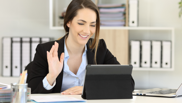 Person waves at people on video call