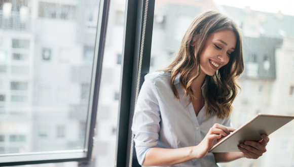 Person smiles at a tablet