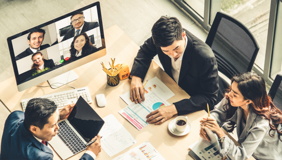 People in-office and on a video call talking during a meeting