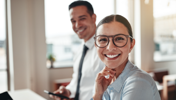 Two salespeople smile