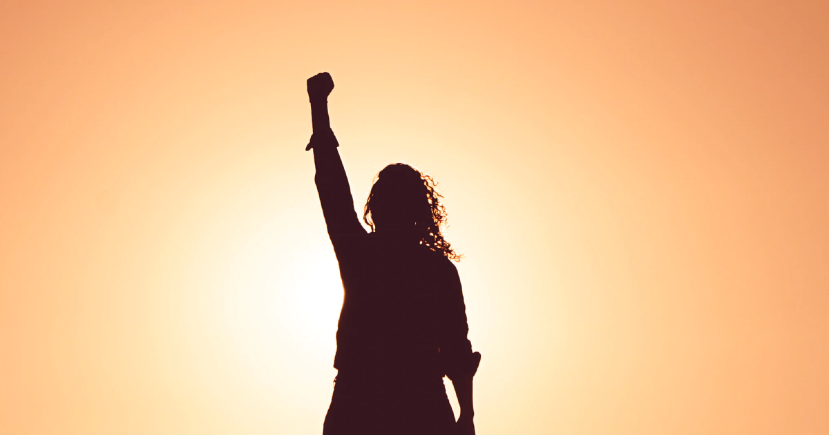 Silhouette of person with raised fist