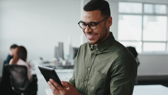 Person smiling at tablet